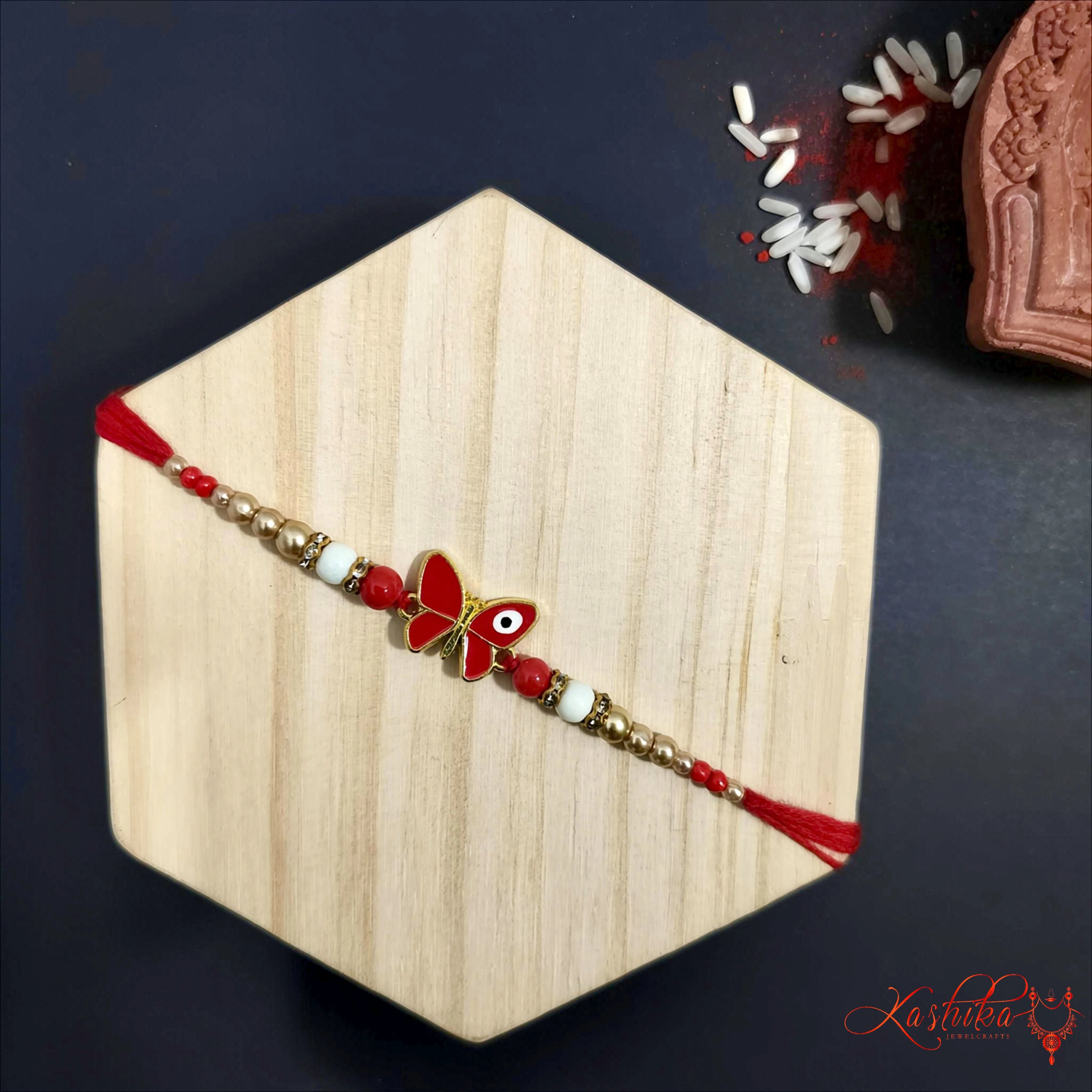 Red Butterfly Pearl Rakhi for Kids & Teens product image by Kashika JewelCrafts