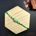 Green Beaded Rakhi with floral design product image by Kashika JewelCrafts