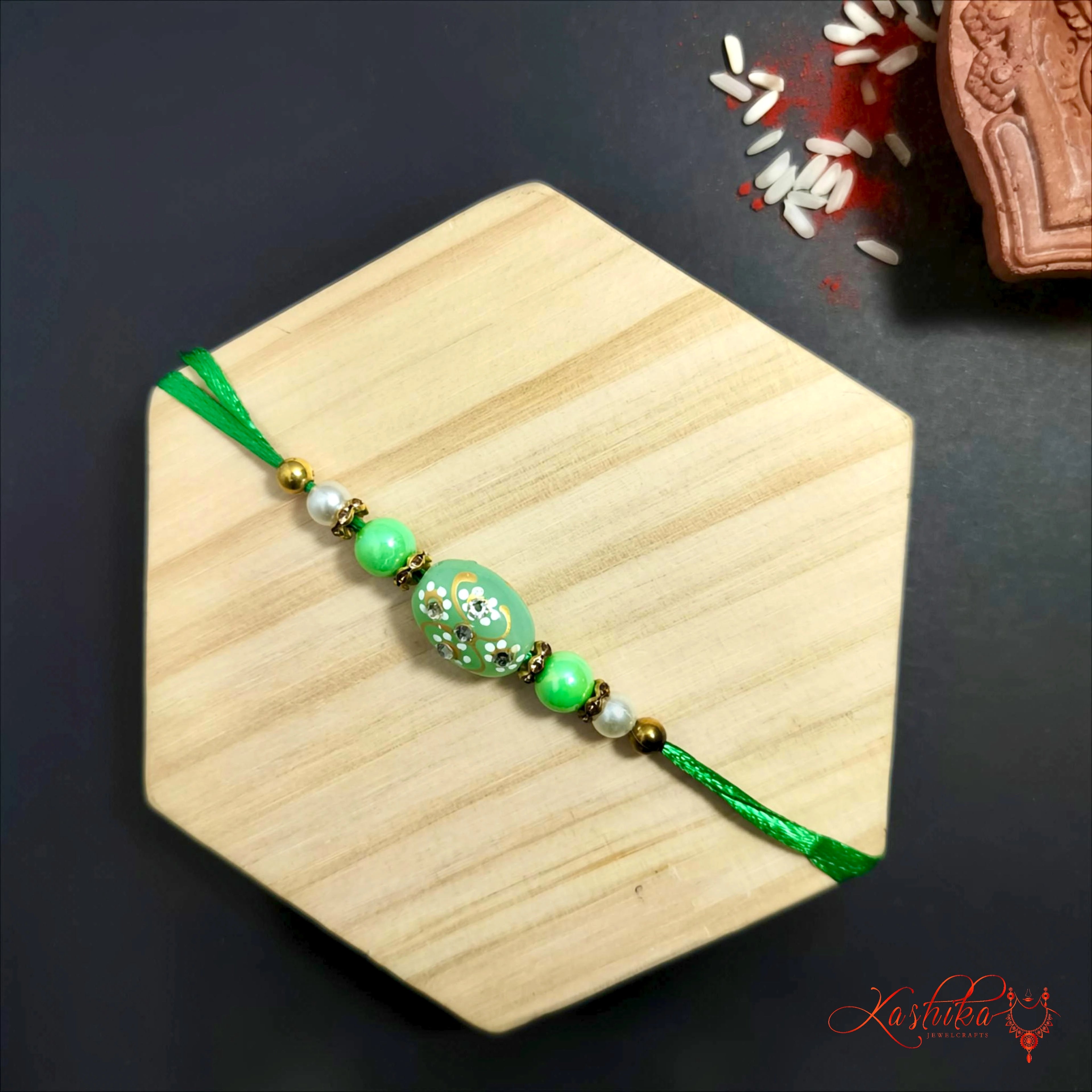 Green Beaded Rakhi with floral design product image by Kashika JewelCrafts