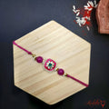 Enamel Meenakari Pink Rakhi with Green Stone - Traditional RakshaBhandhan product image by Kashika JewelCrafts