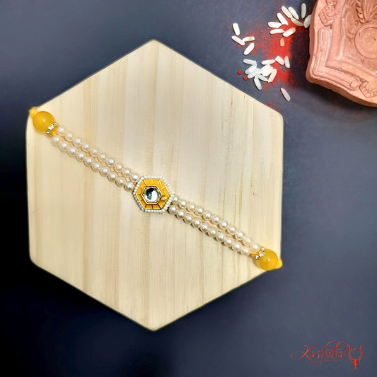 Double line pearl rakhi with a central white kundan stone , on a light wooden hexagon