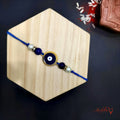 Golden Framed Evil Eye Rakhi - Protective Blue Raksha Bandhan product image by Kashika JewelCrafts