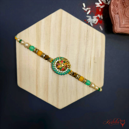 Elegant floral Kundan Rakhi with green , gold and white beads on a wooden background for rakshabandhan