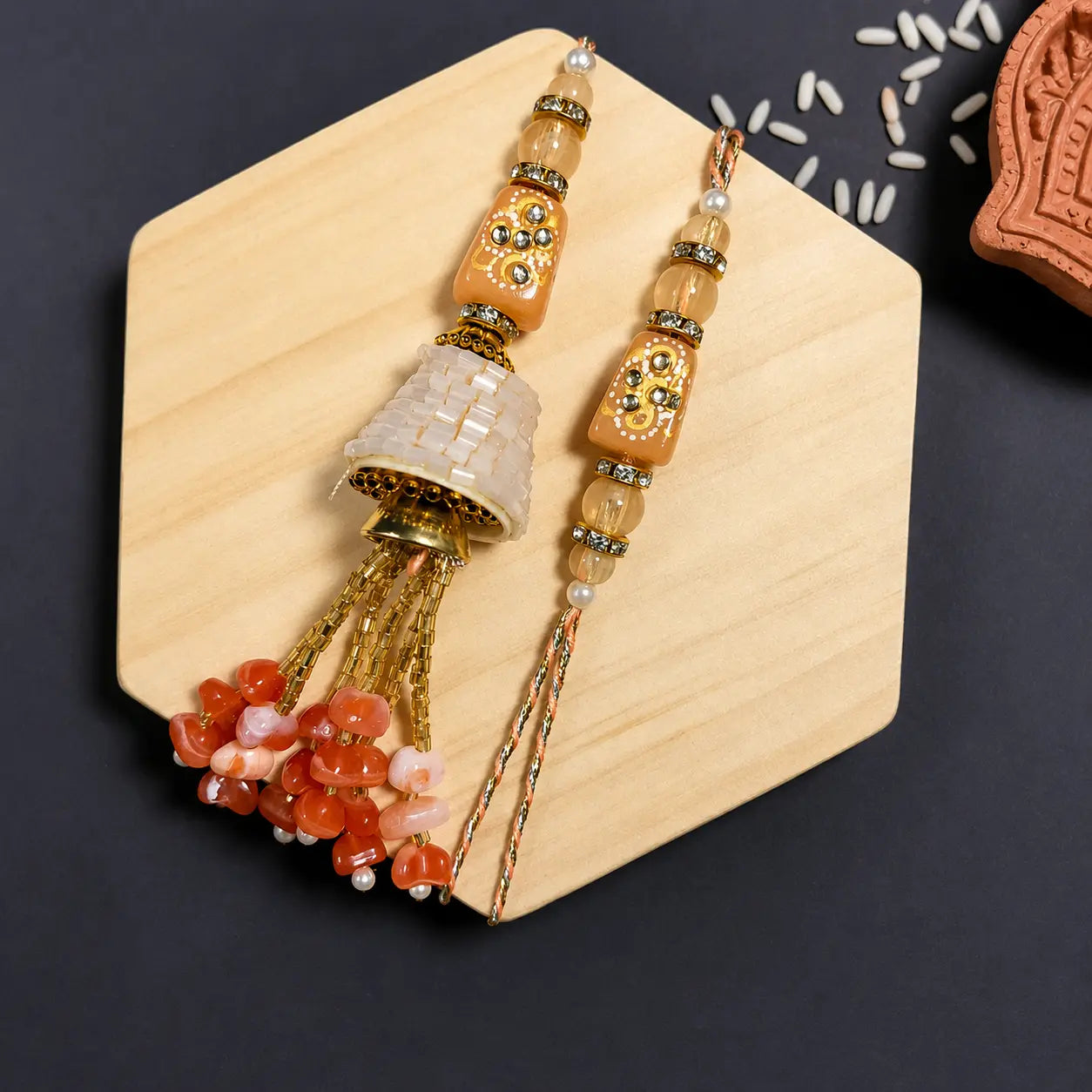 Handmade peach Bhaiya Bhabhi Couple Rakhi Set featuring a designer Rakhi and matching Lumba Rakhi with beaded tassel for Raksha Bandhan.