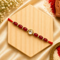 Red Kundan Stone Bhai Rakhi handcrafted with red beads and sparkling crystal spacers, designer Raksha Bandhan rakhi for brother by Kashika JewelCrafts.