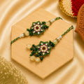 Handmade Green Floral Kundan Bhai Bhabhi Rakhi Set with pearl accents, green beads, and matching designer Lumba Rakhi by Kashika JewelCrafts.