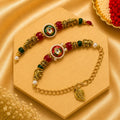 Handmade Royal Elephant Bhai Bhabhi Rakhi Set featuring a teardrop Kundan centerpiece, antique elephant charms, red and green beads, pearl accents, and a matching adjustable Lumba bracelet by Kashika JewelCrafts.