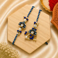 Handmade Blue Lotus Bhai Bhabhi Rakhi Set with pearl detailing, blue beads, and designer Lumba Rakhi by Kashika JewelCrafts.