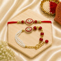 Handmade Red Enamel Kundan Bhai Bhabhi Rakhi Set with pearl strands, red beads, and designer Lumba Rakhi by Kashika JewelCrafts