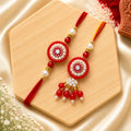 Handmade Red Floral Bhai Bhabhi Rakhi Set with pearl detailing and designer Lumba Rakhi by Kashika JewelCrafts
