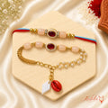 Handmade Peach Kundan Bhai Bhabhi Rakhi Set with oval Kundan centerpiece, pearl detailing, and designer Lumba Rakhi by Kashika JewelCrafts.