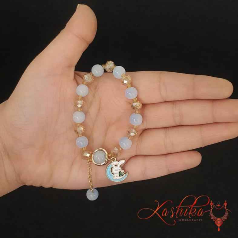 Soft blue and gold toned beads, with a moon and bunny charm - Kashika JewelCrafts