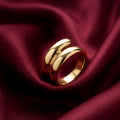 Gold ring on a burgundy fabric background
