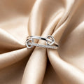 Silver ring with small diamonds on a beige fabric background