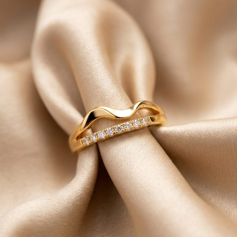 Gold ring with diamonds on beige satin fabric