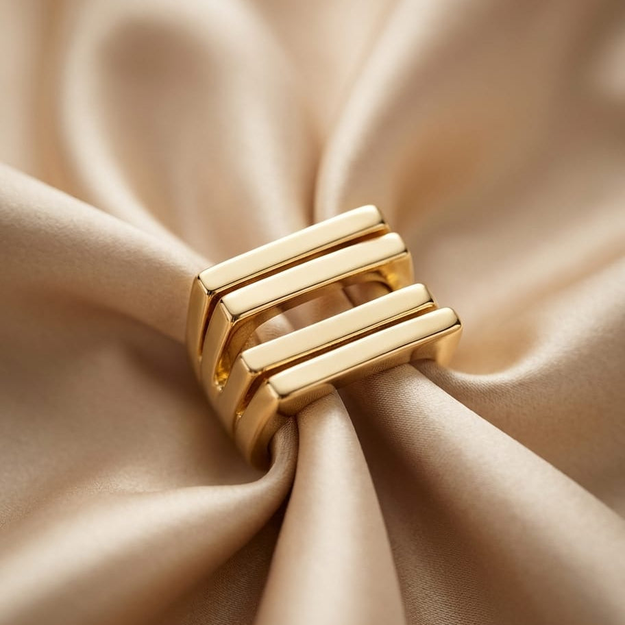 Gold ring on beige fabric