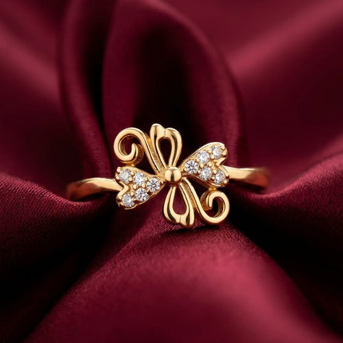 Gold butterfly ring with diamonds on a burgundy fabric background