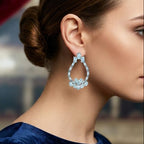 Close-up of a woman wearing a blue earring with a blurred background