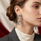 Woman wearing silver earrings with a blurred background
