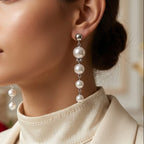 Woman wearing pearl earrings with a blurred indoor background